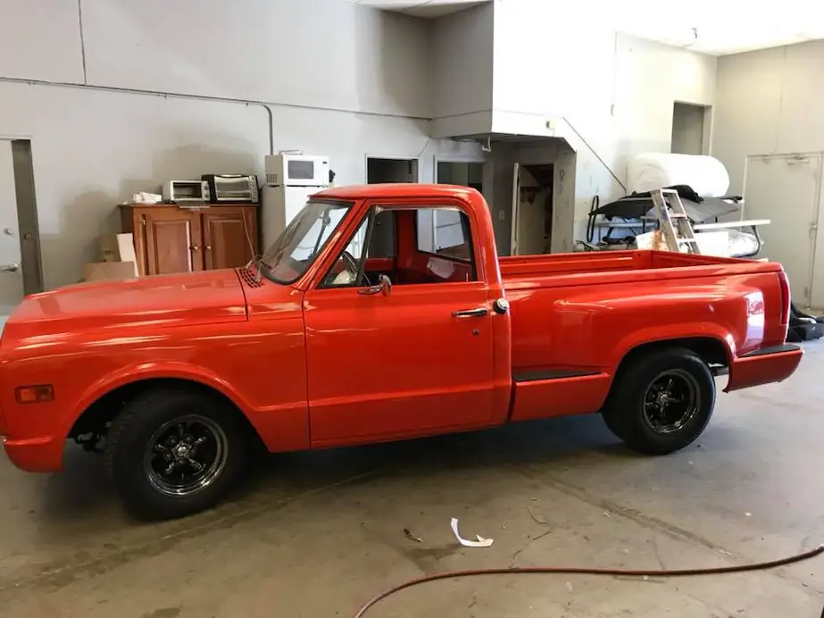 A classic red pickup on the shop floor.