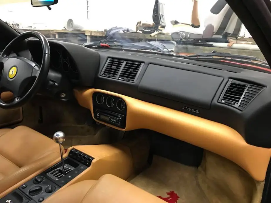 A Ferrari dash with tan leather lower panels.