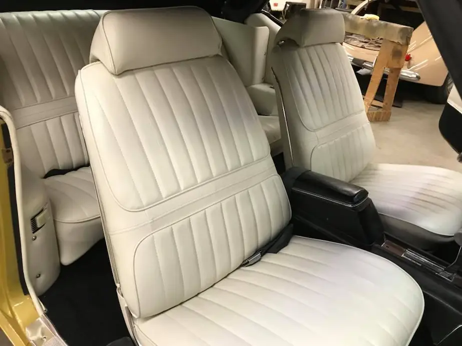 Classic bucket seats in white pleated vinyl.