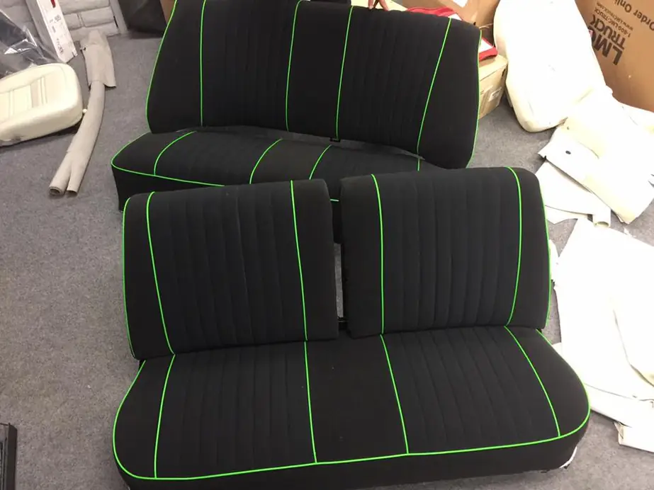 Black cloth bench seats with lime-green piping.