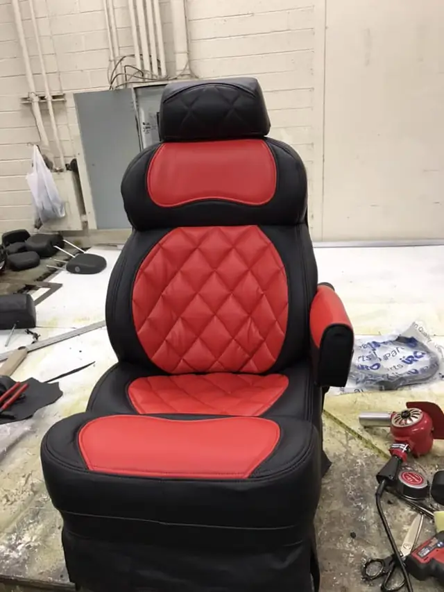 Captain's chair re-covered in black leather with red diamond-quilted inserts